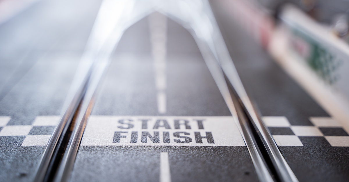 The starting and finish line of a slot car race track. The words 