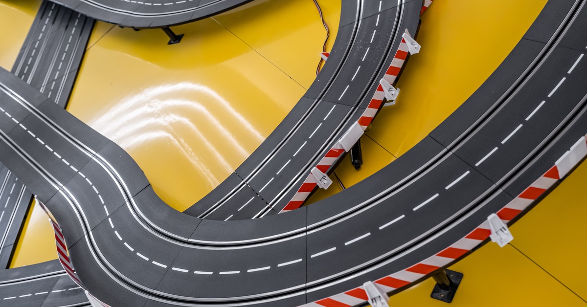 A series of slot car racing tracks stacked over top of one another. Their curves overlap in several places.